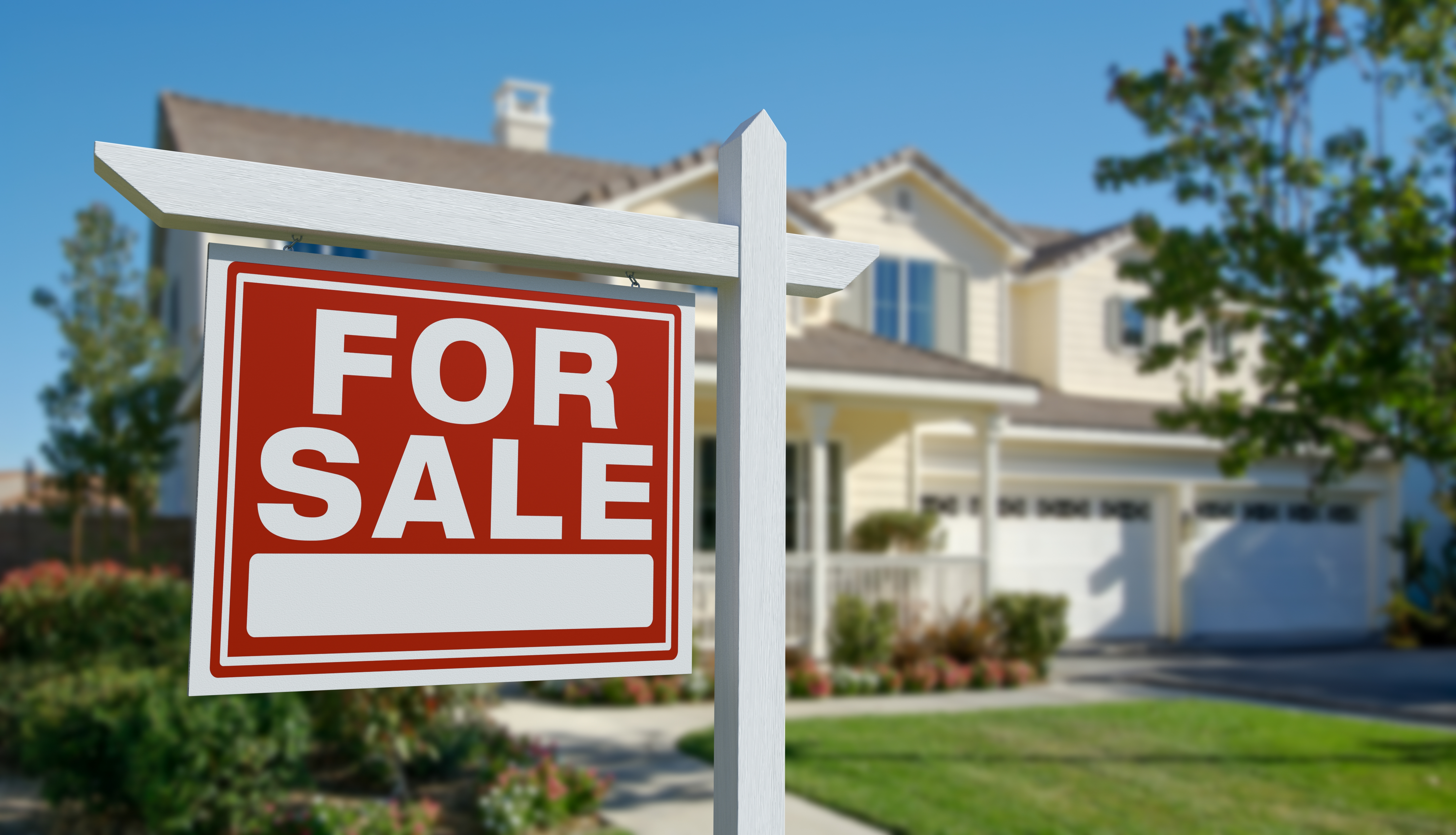 A red For Sale sign in front of a home in Nassau County where residential real estate transactions need legal representation.