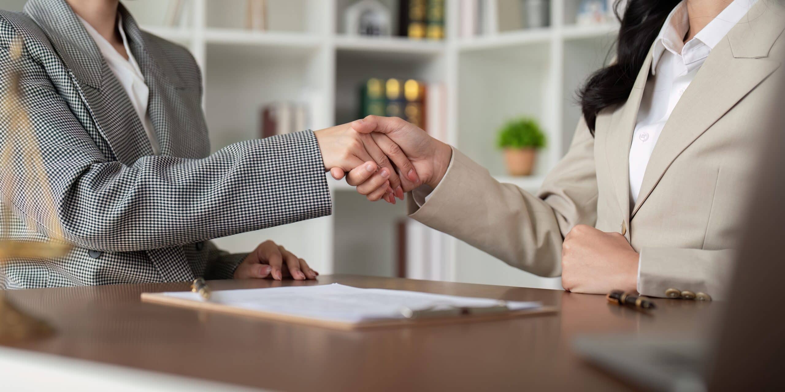Client shaking hands with their residential seller legal representation for Nassau County.