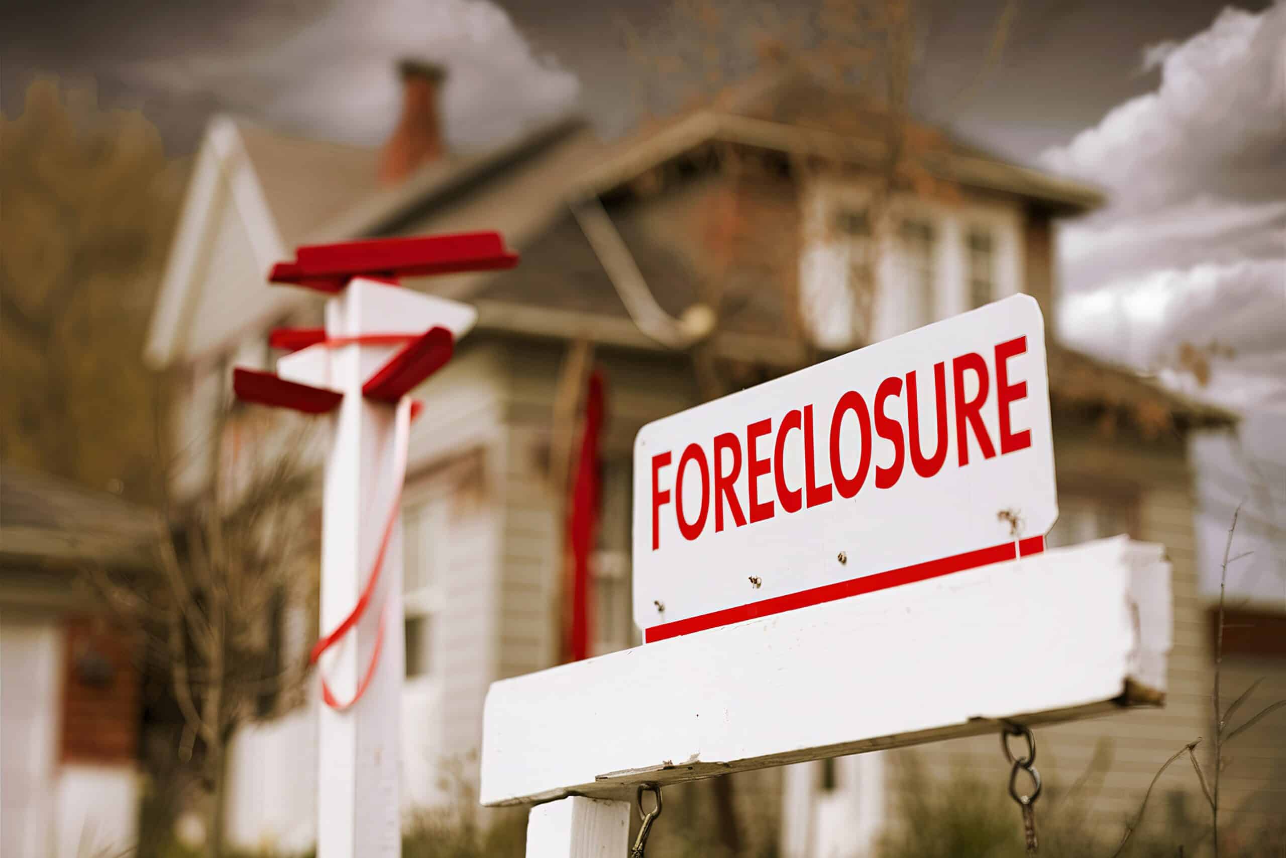 Close up of a foreclosure sign in front of a house after a foreclosure action was filed by a foreclosure lawyer.